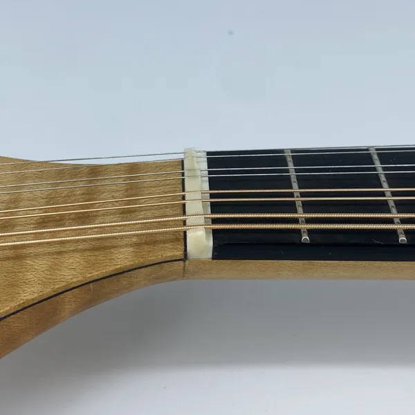 Electric mandolin compensated nut